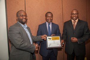Sproxil CEO Ashifi Gogo, (left), receives a certificate from Acumen  East Africa CEO Duncan Onyango (centre) and Andrew Waititu MD SAP East  Africa