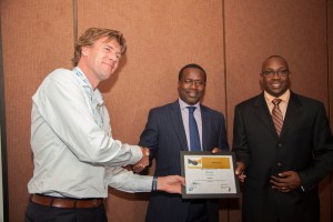Solar now CEO Willem Nolens (left), receives an award from SAP East  Africa CEO Andrew Waititu (right) and Acumen East Africa CEO Duncan Onyango.